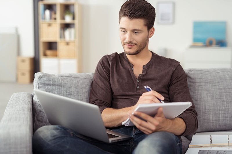 Man on sofa researching