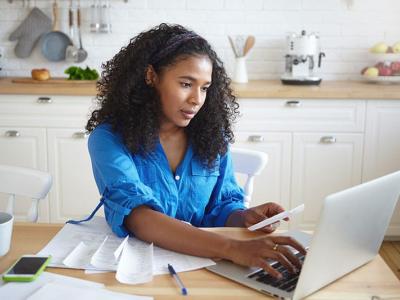Women in kitchen with laptop