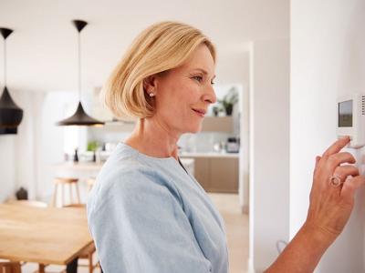 Older woman with thermostat