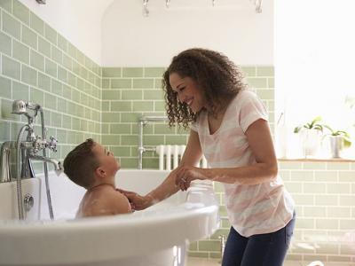 woman with boy in bath