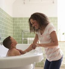 woman with boy in bath