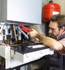 man repairing condensing boiler