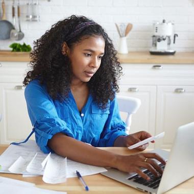 Women in kitchen with laptop