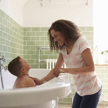woman with boy in bath