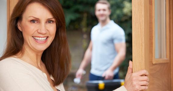 women with tradesperson at door